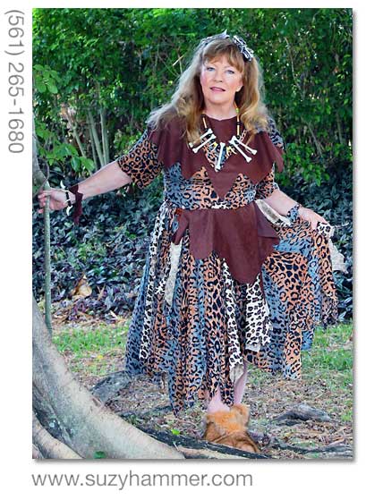 Suzy Hammer in her highly fashionable cavewoman outfit, posing by a tree.