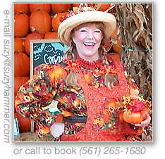 Patty by cornstalks and pumpkins.